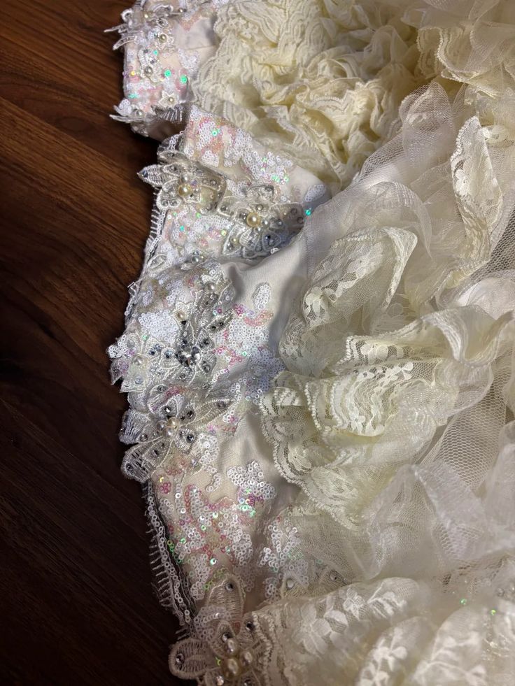 Vintage-Inspired Ivory Lace Ball Gown with Ruffled Details & Satin Bow Accents DP7008