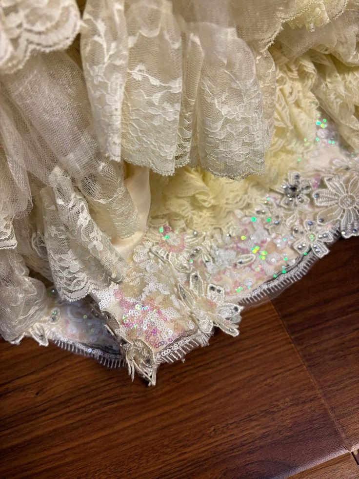 Vintage-Inspired Ivory Lace Ball Gown with Ruffled Details & Satin Bow Accents DP7008