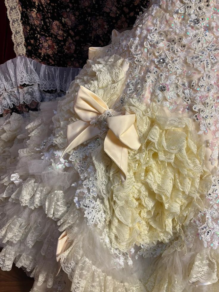 Vintage-Inspired Ivory Lace Ball Gown with Ruffled Details & Satin Bow Accents DP7008